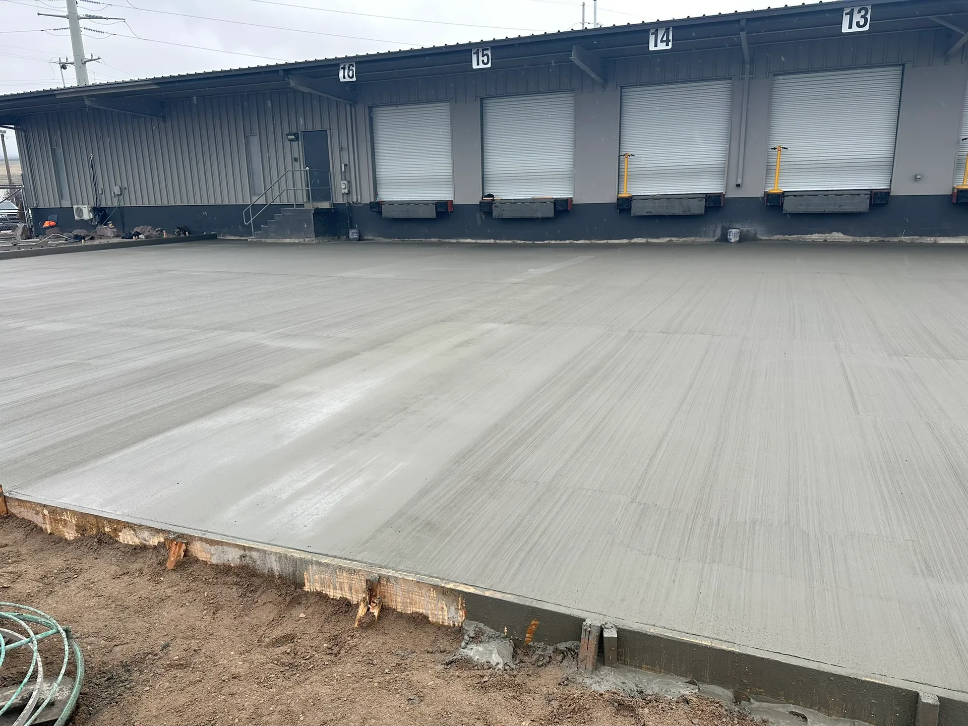 Finished concrete slab beside warehouse loading bays